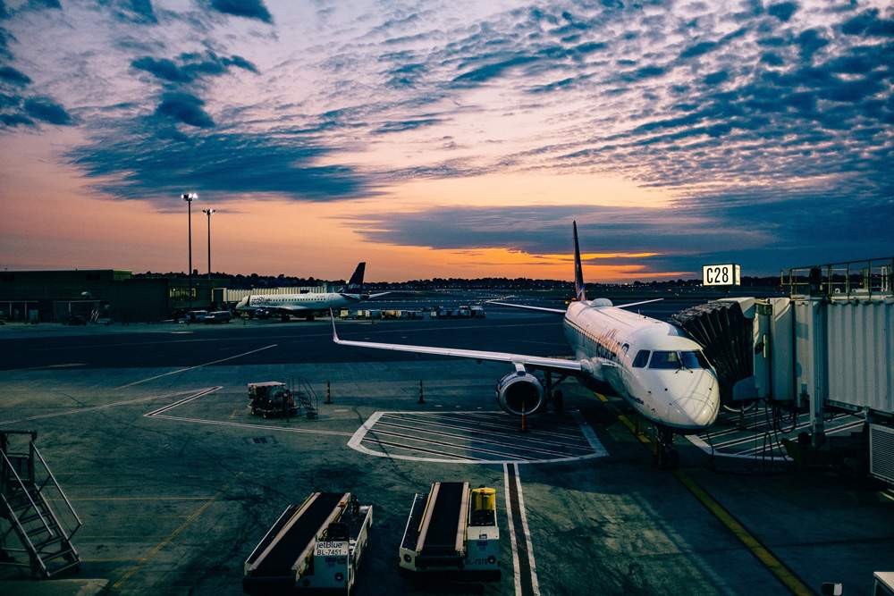 pista de aterrizaje de un aeropuerto con el avión en un finger